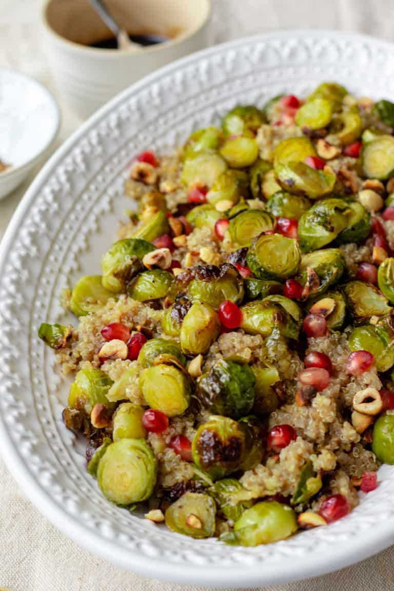 This is the festive salad of your dreams! Maple roasted brussel sprouts tossed with nutty quinoa, fresh apple, crunchy toasted hazelnuts and tangy pomegranate all liberally drizzled with a sticky balsamic reduction. The most perfect pretty lunch. Vegan, GF & healthy!