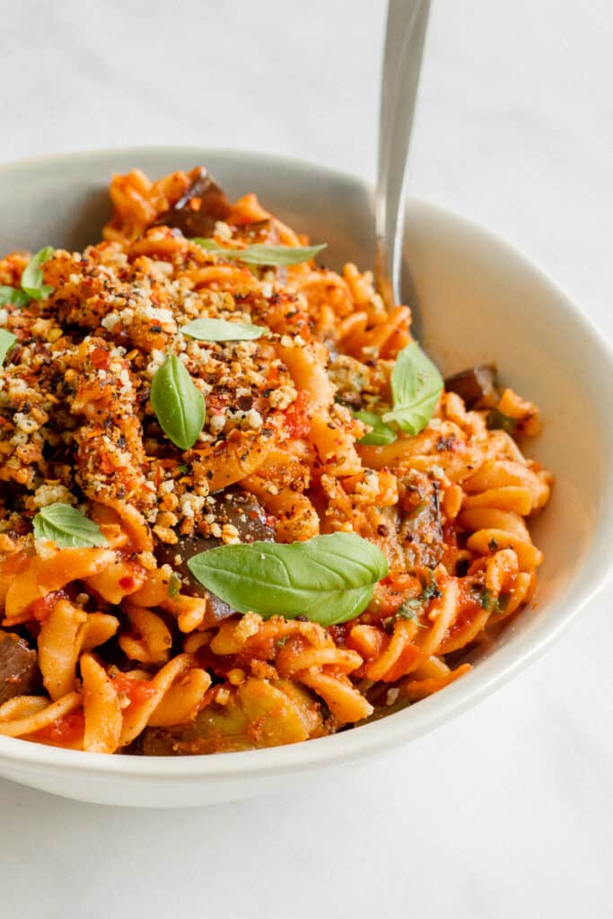 A bowl of Pasta alla Norma Topped With Crunchy Almond Crumb - Vegan, GF & Healthy! Georgie Eats.