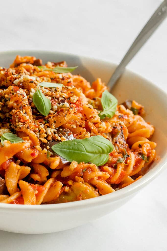 A bowl of Pasta alla Norma Topped With Crunchy Almond Crumb - Vegan, GF & Healthy! Georgie Eats.