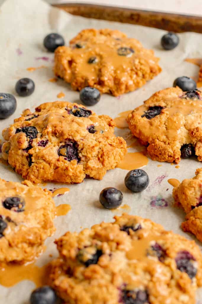 Blueberry Crumble Cookies on Baking Tray with Cashew Drizzle - Vegan, GF & Healthy! Georgie Eats.