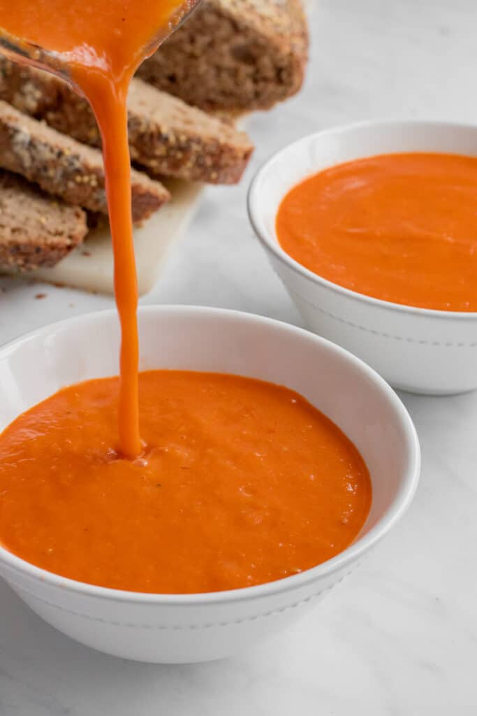 Pouring the tomato soup into bowls.