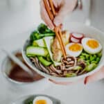 Using chopsticks to eat the Miso Noodle Bowls - GF & Healthy! Georgie Eats.