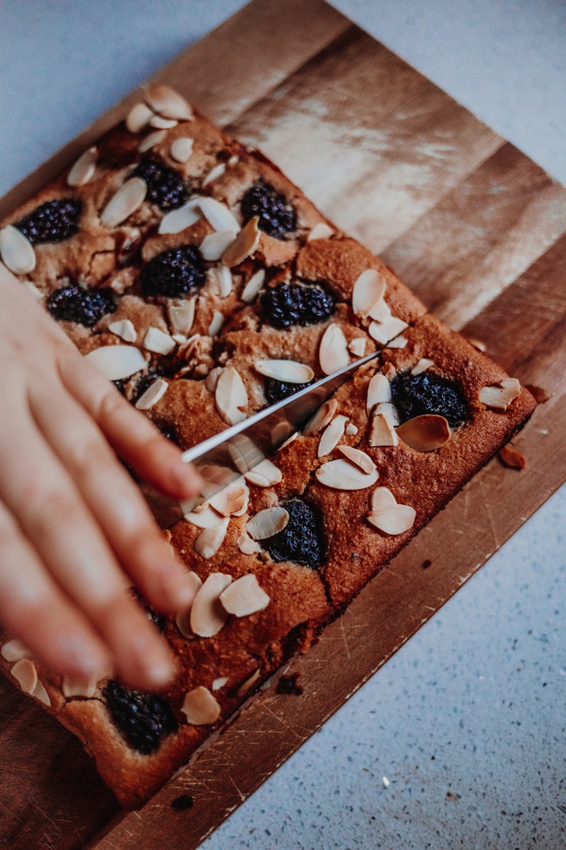 Chopping the Blackberry Bakewell Bars into slices