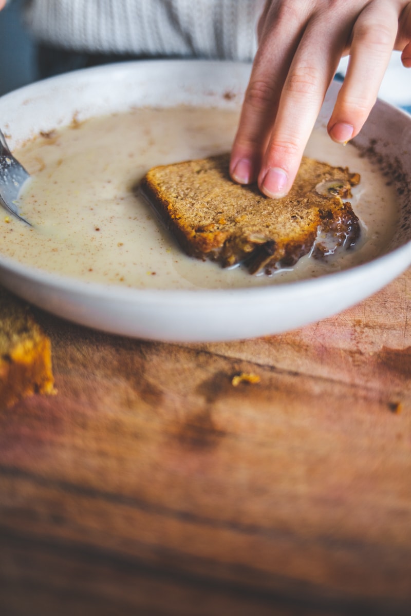 Dipping the Vegan Banana Bread French Toast in flaxseed - Georgie Eats