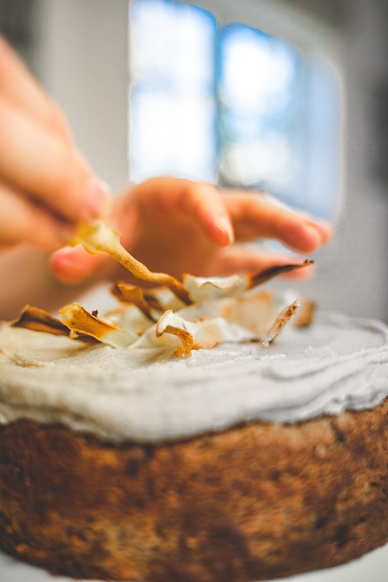 decorating the Spiced Parsnip Cake with Vanilla Cashew Frosting - Georgie Eats