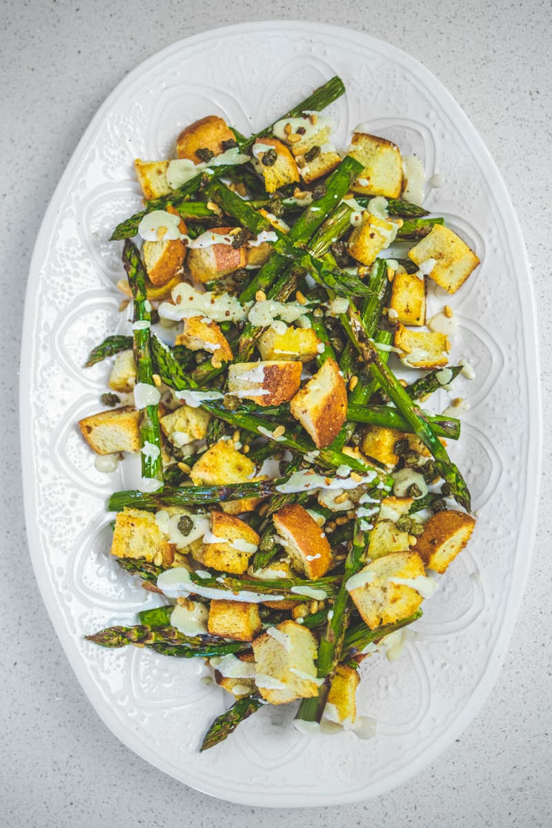 Asparagus Caesar Salad on a serving dish - Georgie Eats