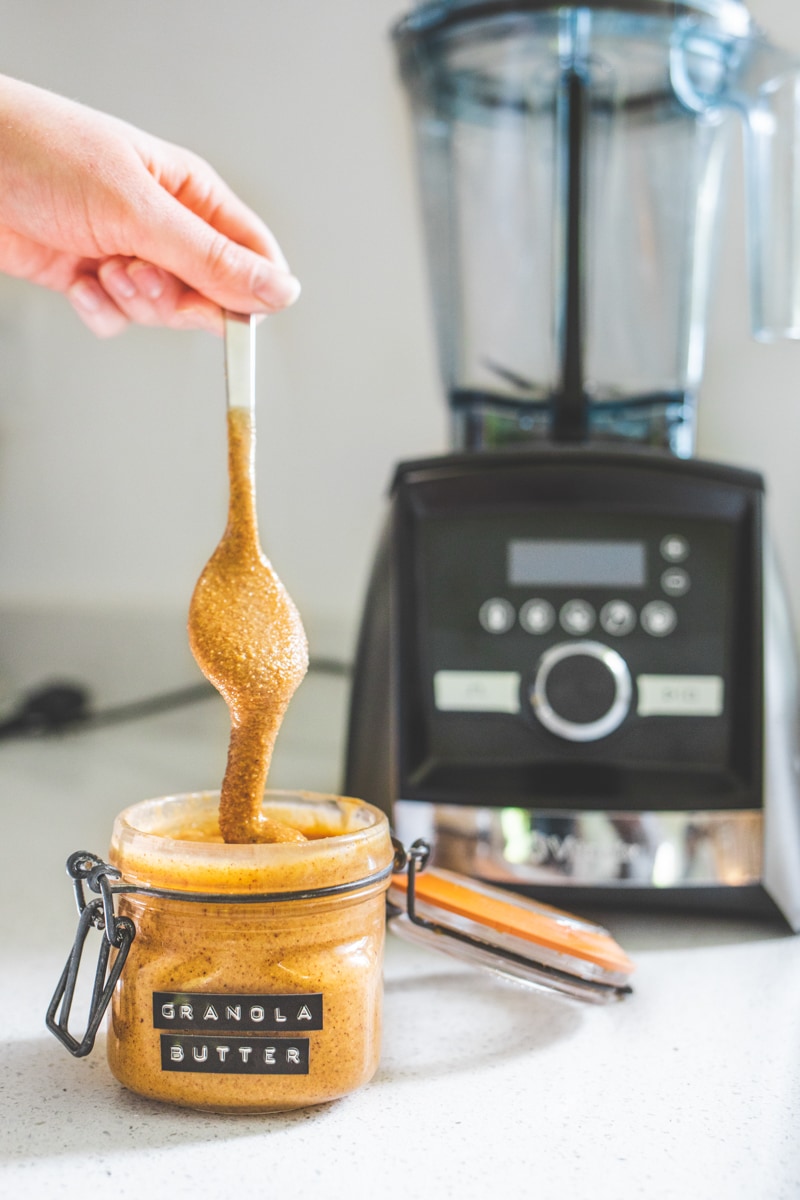 Vegan Granola Butter next to a vitamix - Georgie Eats