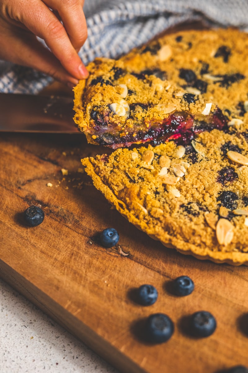 slicing the Blueberry Frangipane Tart - Georgie Eats