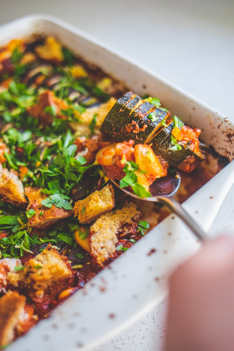 A spoonful of Hasselback Courgette Bake with Harissa & Croutons - Georgie Eats