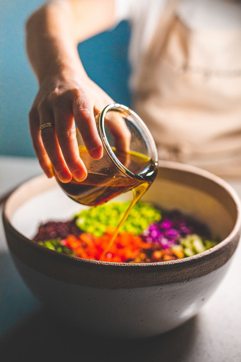 Pouring Miso Dressing over Rainbow Rice Salad - Georgie Eats