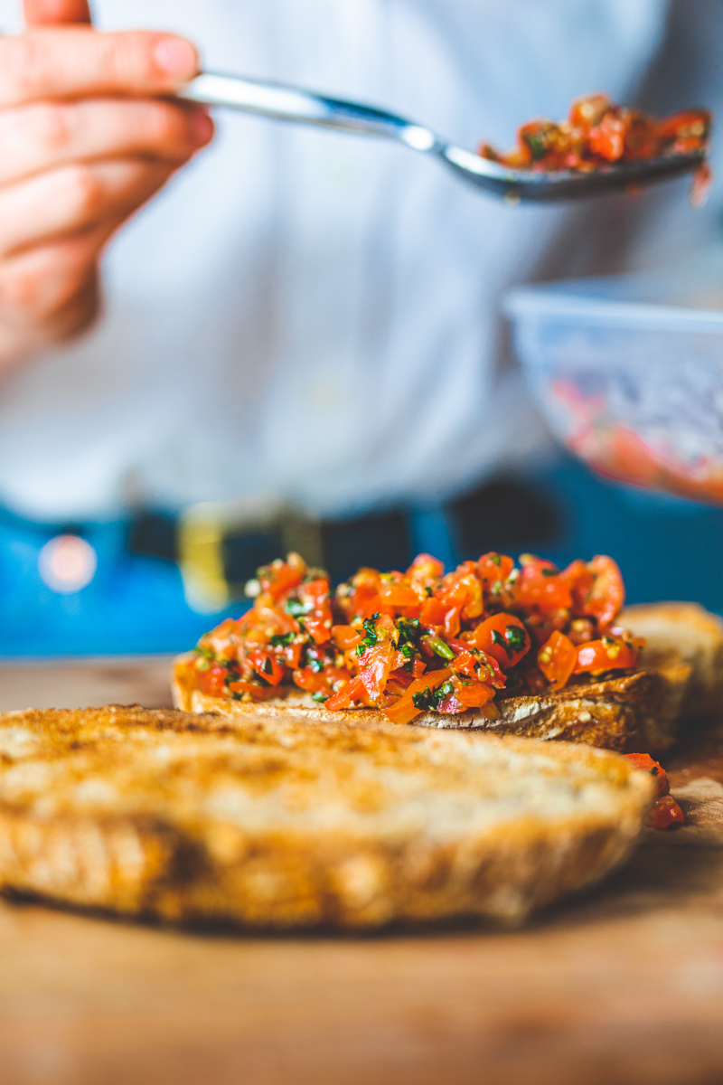 Adding the Best Ever Bruschetta onto toasts - Georgie Eats