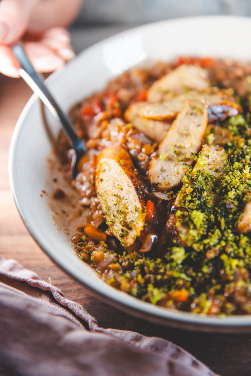 a bowl of Red Pepper Lentils, Sausages & Salsa Verde Crumb - Georgie Eats