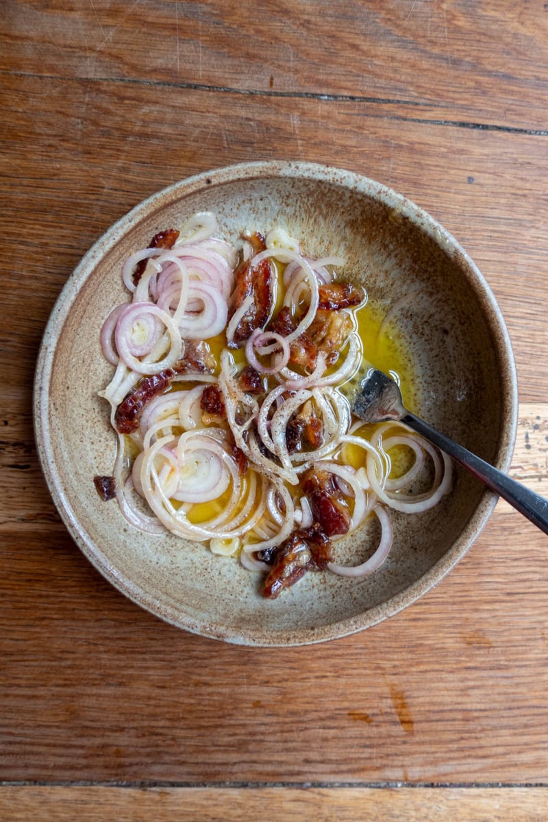 A bowl with shallots, vinegar, mustard, and dates - Georgie Mullen